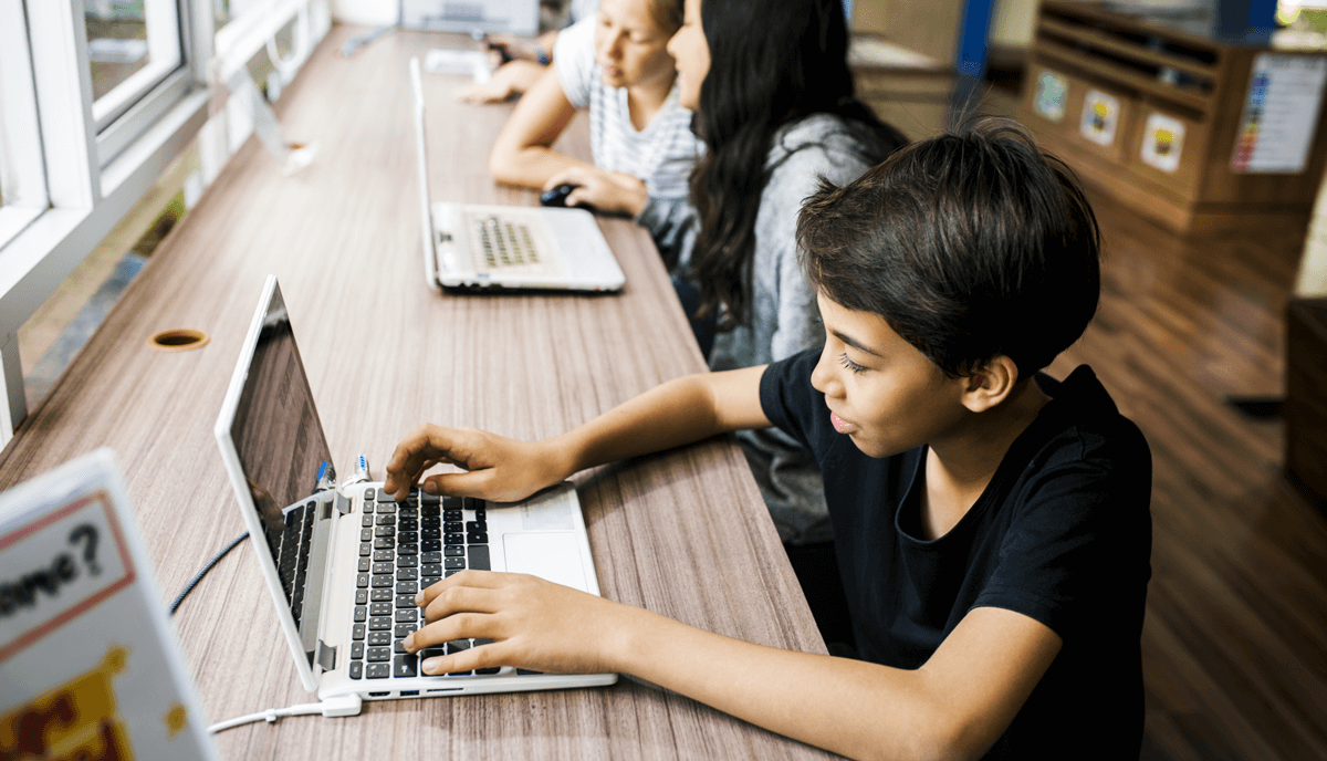 Student sitting in class and learning with a laptop